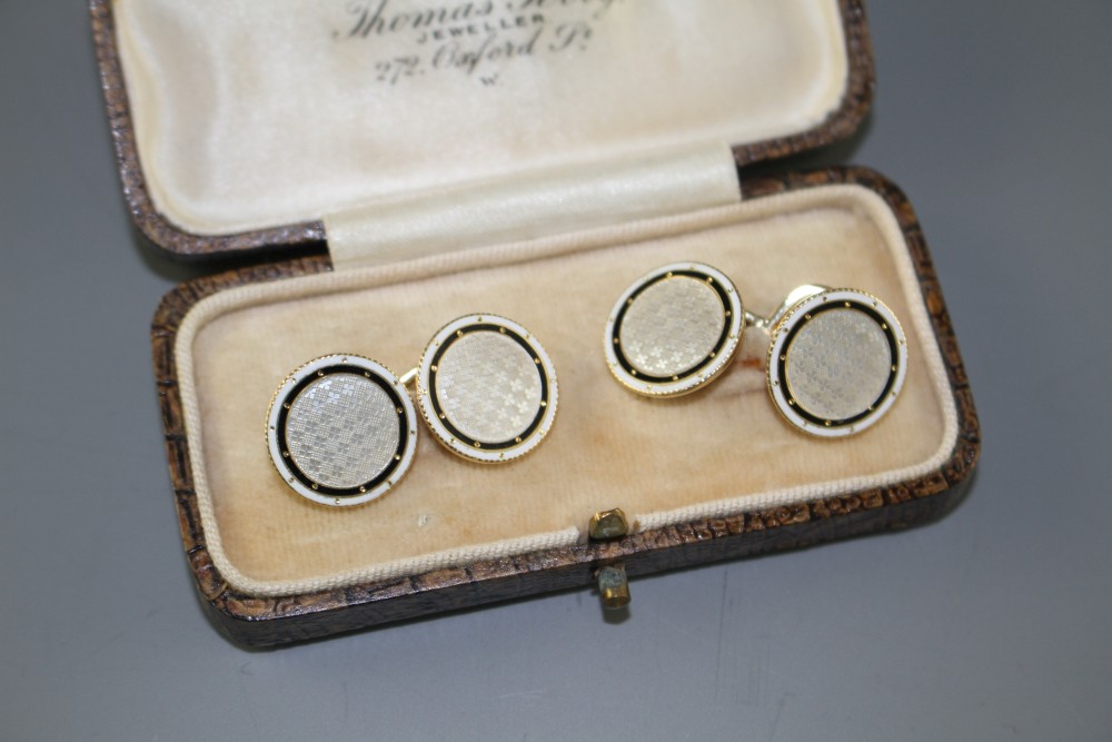 A pair of yellow metal (stamped TM 18ct), mother of pearl and enamel disc cufflinks, gross weight 10 grams, disc 14mm.